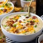 Potato soup in bowl, with toppings