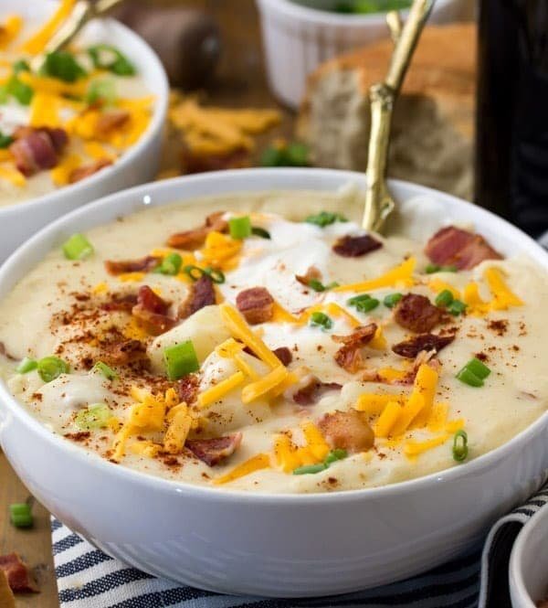 Potato soup in bowl, with toppings