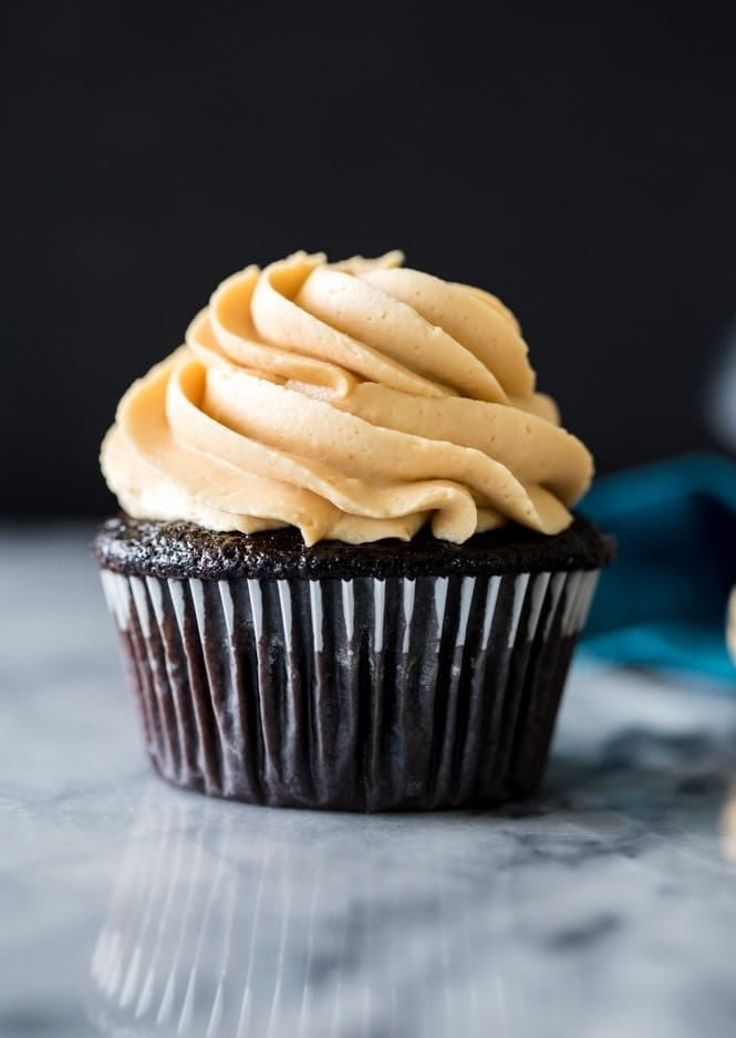How to make DARK CHOCOLATE CUPCAKES! These are so soft and moist and topped off with a silky peanut butter frosting! #cupcakes #baking #recipe #darkchocolate Dark Chocolate Cupcake topped with Peanut Butter Frosting