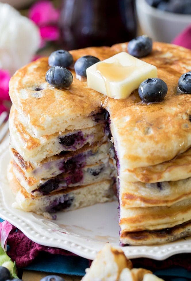 How to make Blueberry Pancakes from scratch! These were SO GOOD! And so easy to make, too! #pancakes #breakfast #easybreakfast #blueberrypancakes #baking A stack of blueberry pancakes
