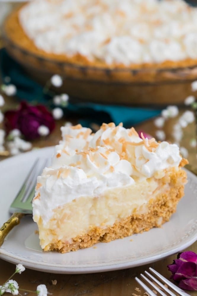 The BEST Coconut Cream Pie Recipe! #pierecipe #coconut #coconutcreampie Slice of coconut cream pie on plate