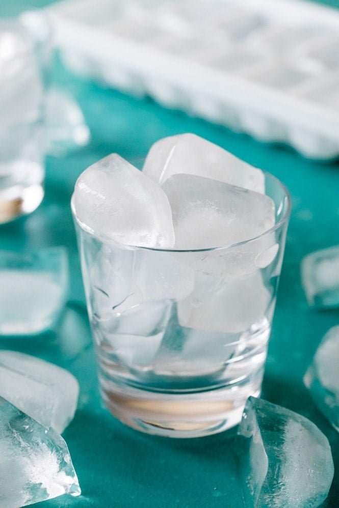 HOW TO MAKE ICE! How did I not think of this! #icerecipe #bestrecipe Ice cubes in a clear glass blue background