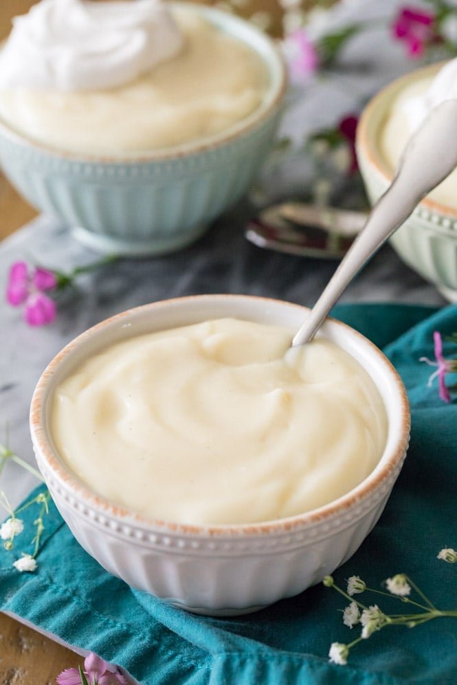 HOMEMADE VANILLA PUDDING! So easy to make with ingredients you already have on hand, no gelatin, no fancy odd ingredients! This is a great easy pudding recipe! #pudding #puddingrecipe #sugarspunrun Homemade vanilla pudding in white bowl