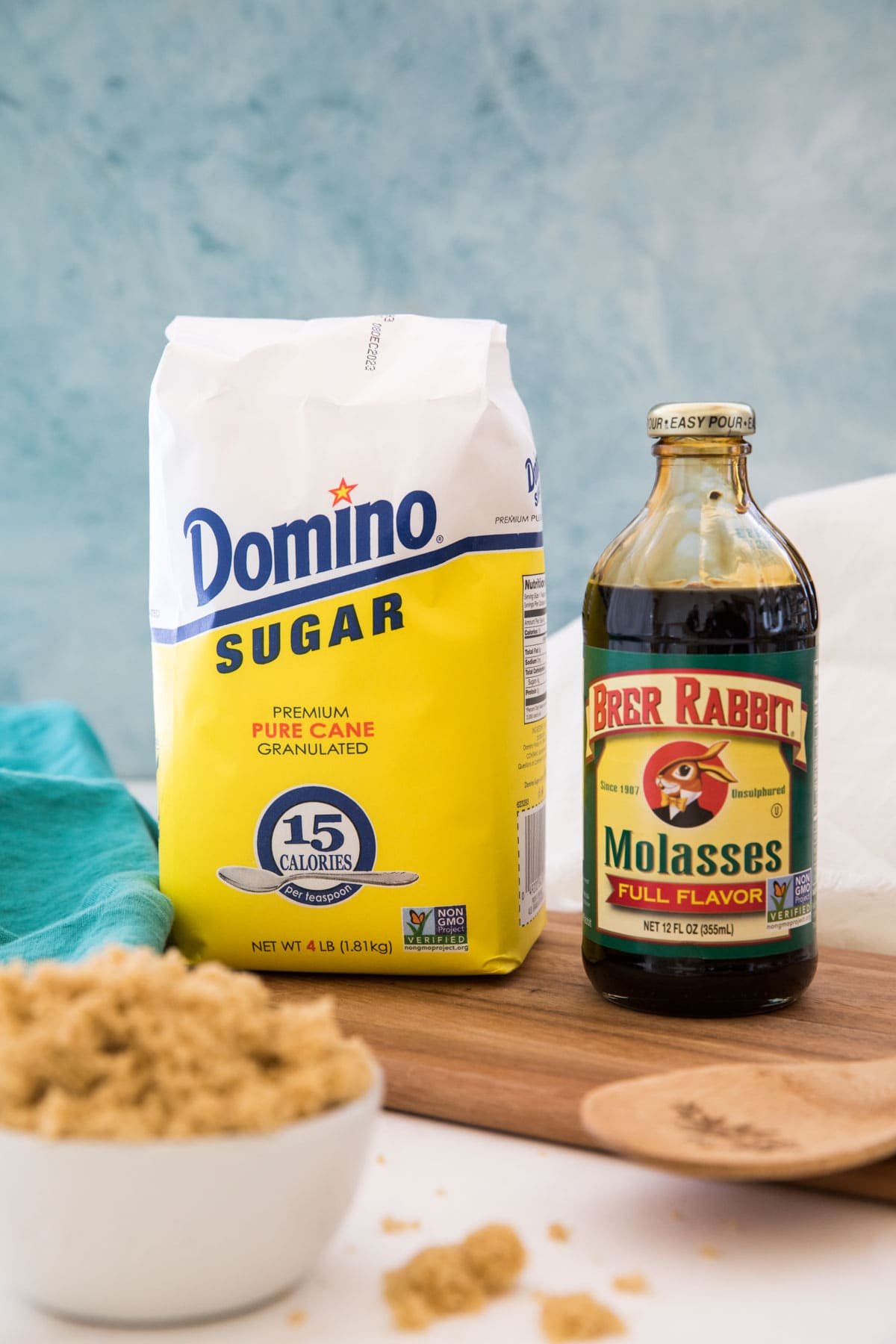 A bag of white sugar and a bottle of molasses