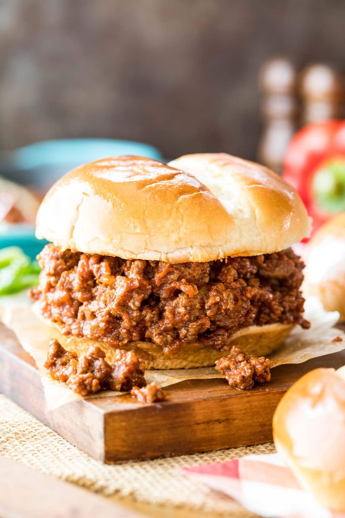 sloppy joe sandwich resting on a wood cutting board