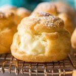 Close-up view of cream puffs filled with pastry cream and dusted with powdered sugar.
