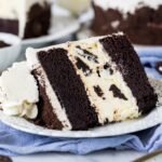 Slice of Oreo cheesecake cake on a plate.