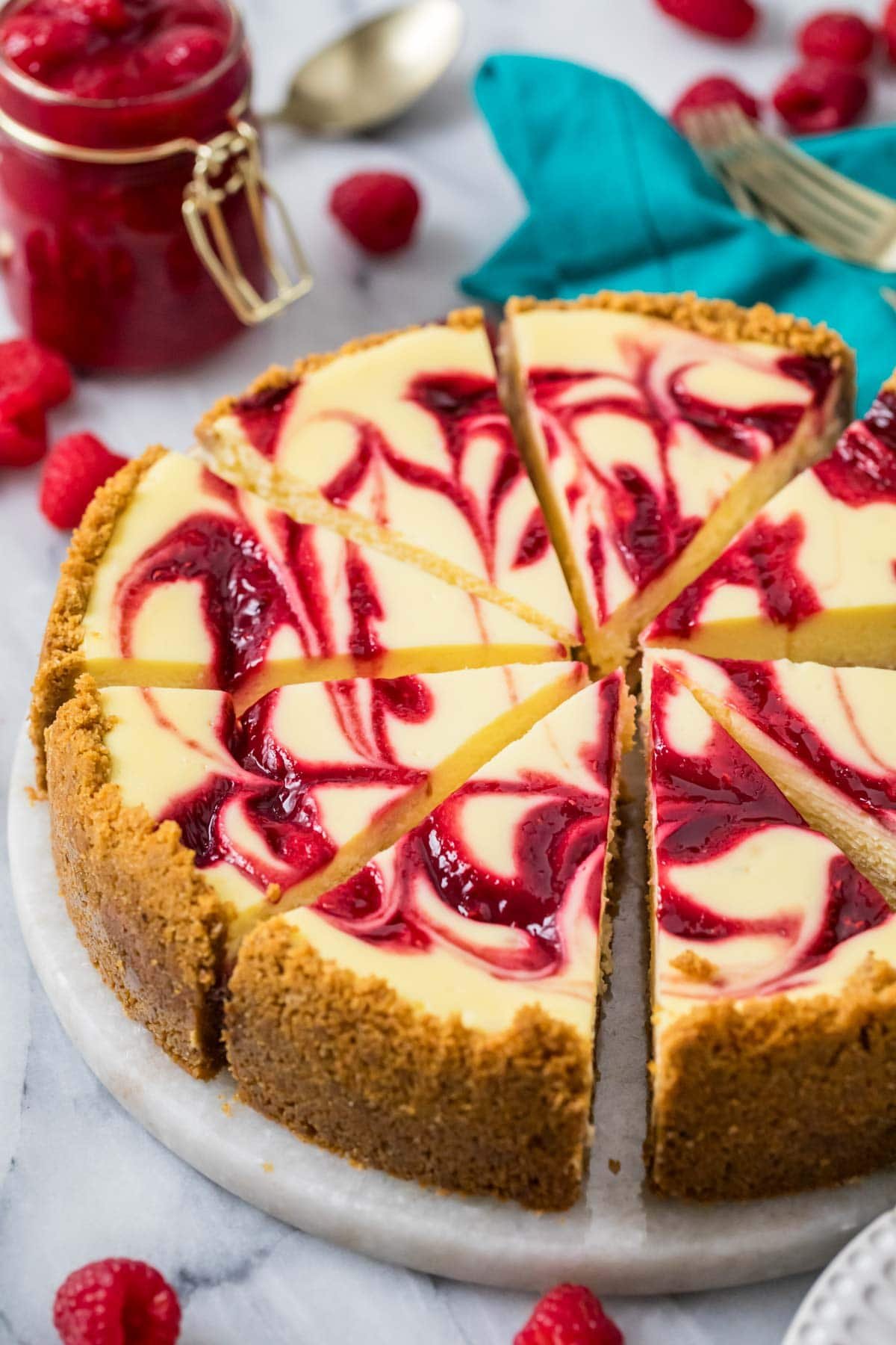 Slices of raspberry cheesecake on a serving platter.