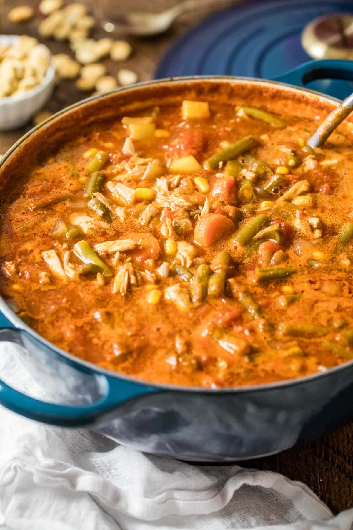 Pot of maryland crab soup made with a tomato base, lump crab meat, old bay, and more.