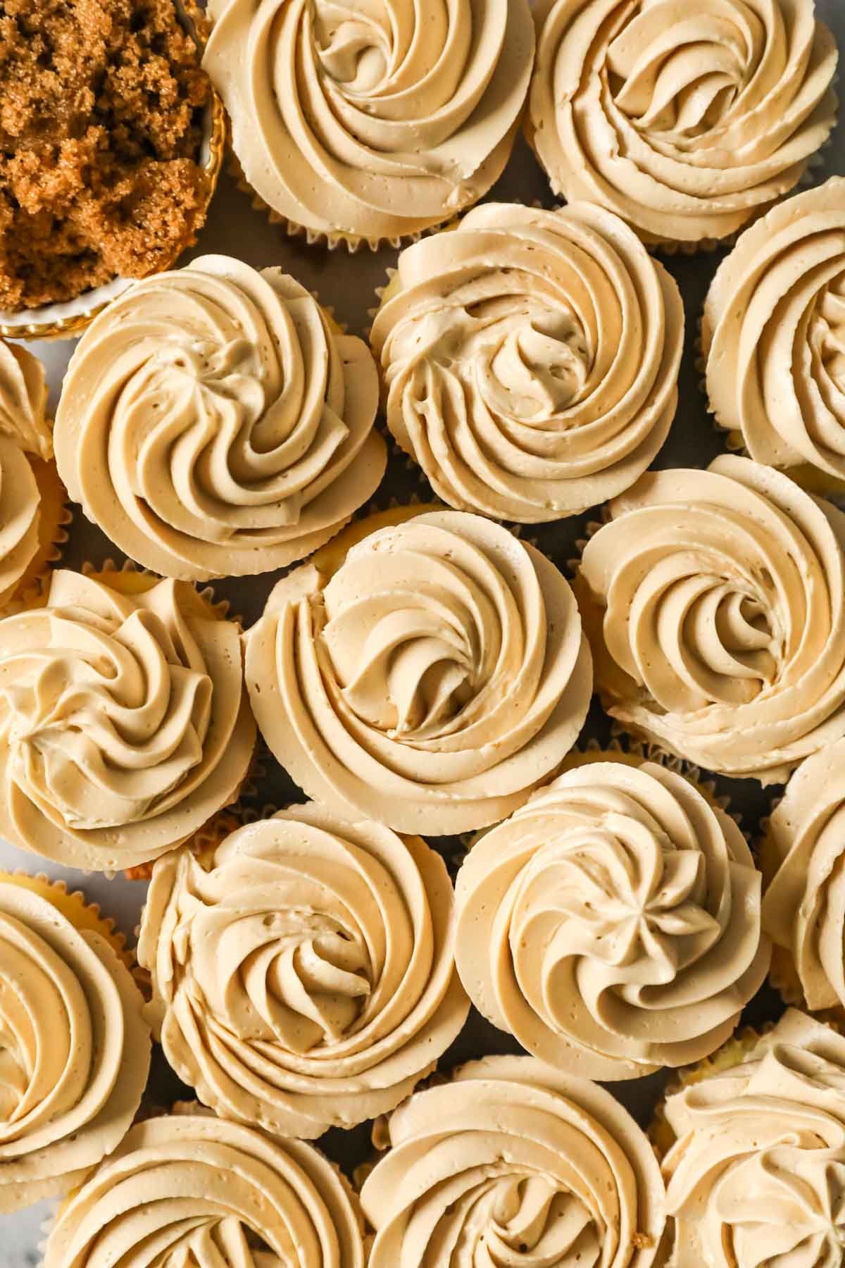 Overhead view of cupcakes frosted with brown sugar swiss meringue buttercream.