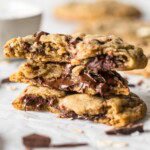 Several halves of choc-oat-chip cookies stacked on top of each other.