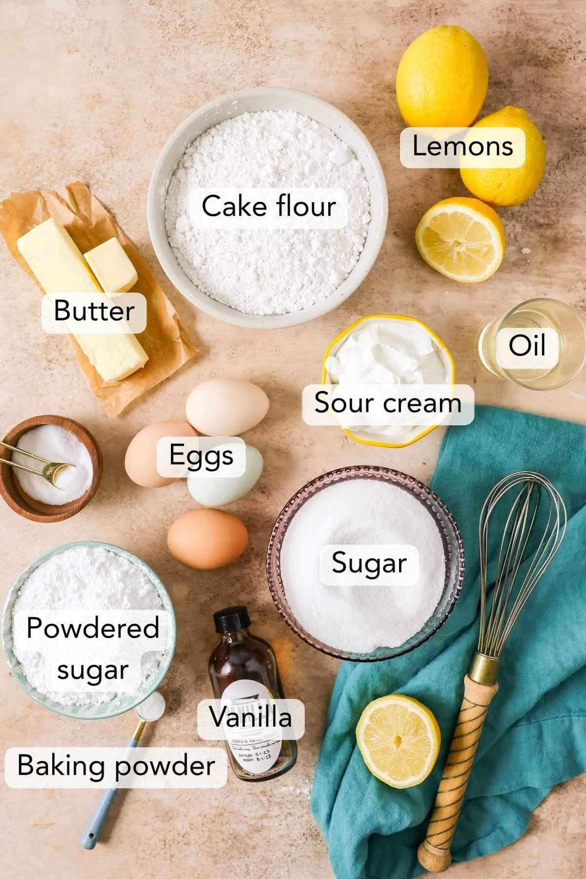 Overhead view of ingredients including eggs, lemons, flour, and more.
