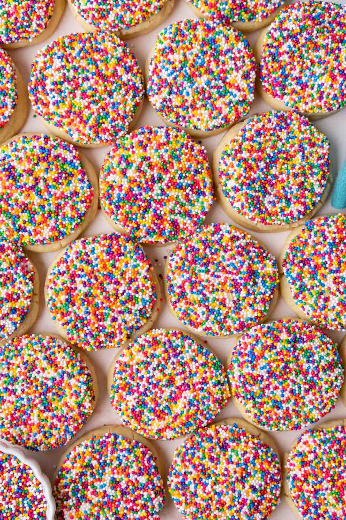 Overhead view of dot cake cookies on a baking sheet.